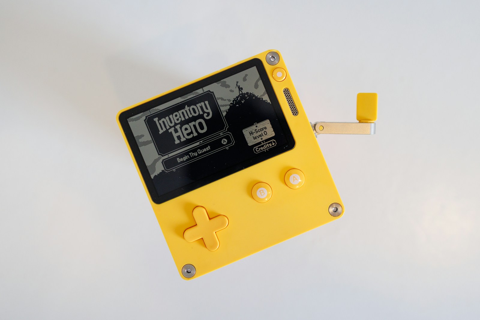 a yellow and black gameboy with a white background